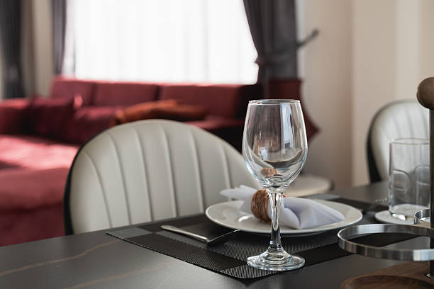 istock Elegant Dining Table Setup with Glassware and Tableware in Contemporary Interior Design with Plush Seating in the Background 2222433424