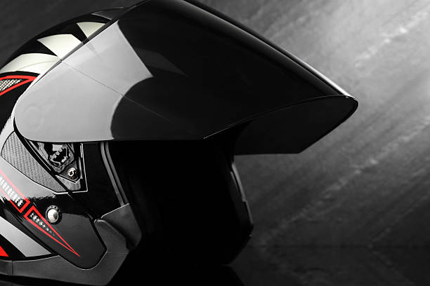 istock Modern motorcycle helmet with visor on dark gray background, closeup 2222435140