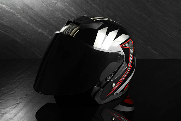 istock Modern motorcycle helmet with visor on dark gray background 2222435143