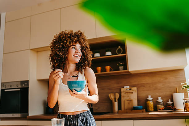 Young woman enjoying a healthy breakfast in her modern kitchen