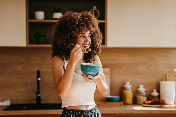 istock Young woman enjoying a healthy breakfast in her modern kitchen 2222444626