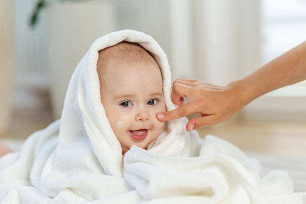 istock Happy baby getting face cream after bath 2222446616