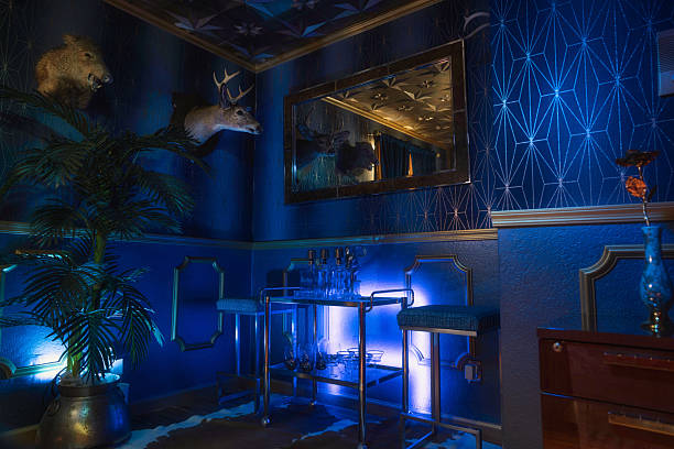 Eclectic Blue Room with Exotic Taxidermy and Backlit Chrome Bar
