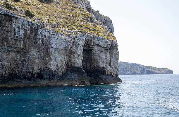 istock rugged coastal cliffs, clear blue sea, mediterranean coastline, limestone formations, natural caves, sea level perspective, island landscape, summer travel, 2222447985