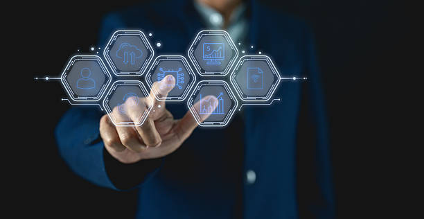 istock A person in a suit interacts with a futuristic digital interface displaying various business and financial icons. 2222448689
