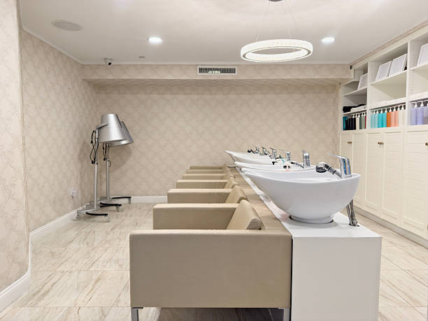 Empty seats in hair salon with washbasins