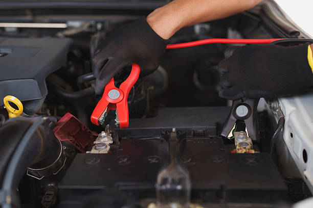 istock Jumper cables to a car battery terminal 2222449763