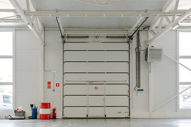 istock Industrial garage door in modern warehouse interior with fire safety system, HVAC ventilation, engineering infrastructure and storage logistics theme 2222450328