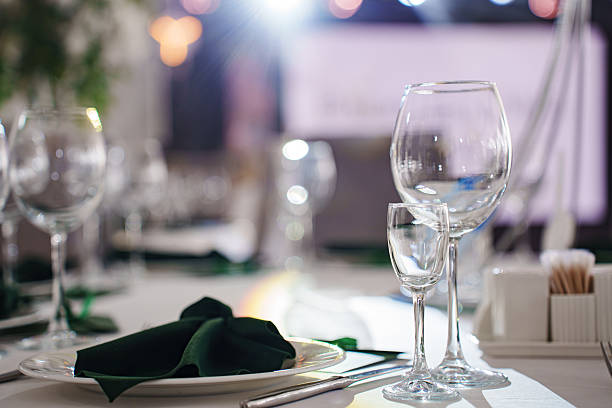 istock Setting the festive table. empty wine glasses and plates with green napkins. 2222450600