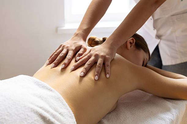 istock Young woman enjoying a massage from a massager at a spa 2222450639