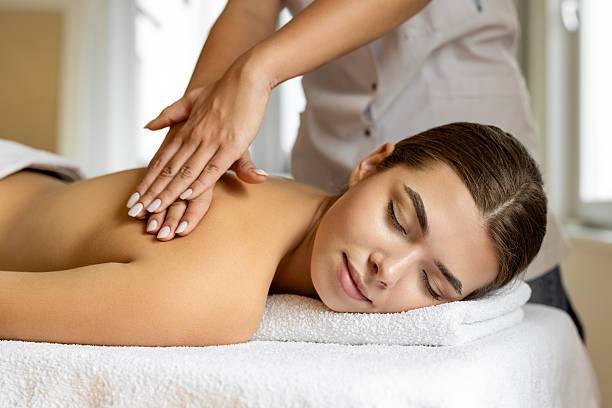 istock Young woman enjoying a massage at a spa 2222450921