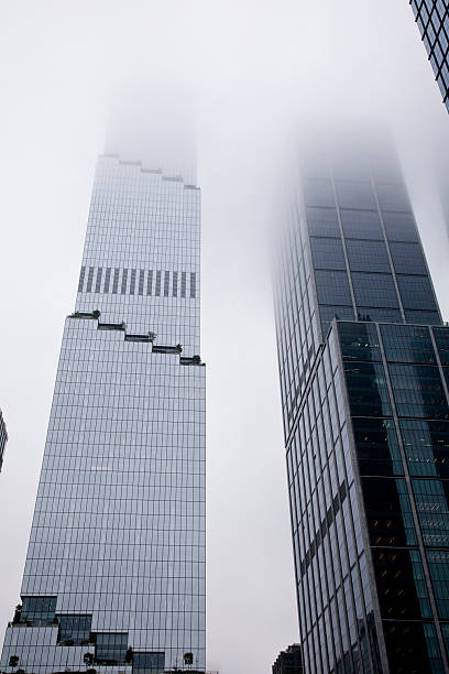 Midtown Manhattan skyscrapers on West Side, in dense clouds.