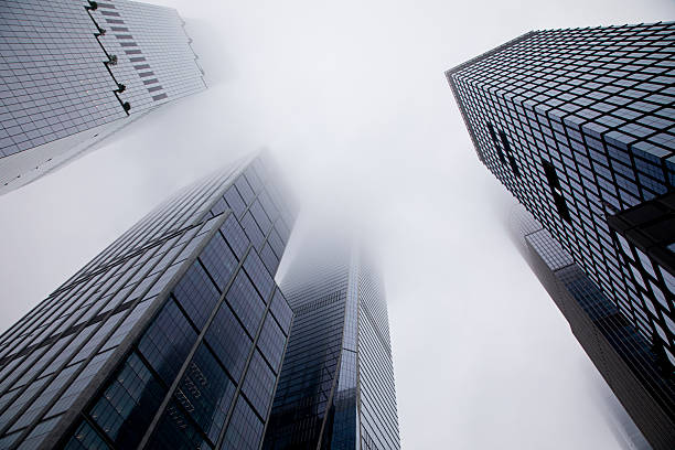 Midtown Manhattan skyscrapers on West Side, in dense clouds.