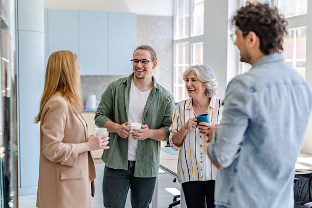 istock Engaging conversation among colleagues in a modern office during a coffee break 2222451272