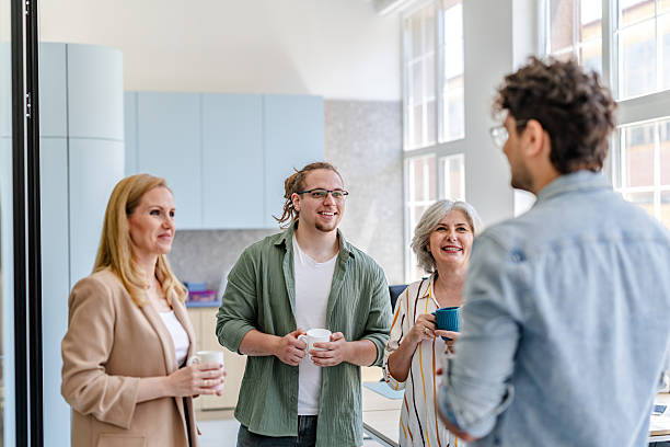 istock Conversations over coffee among colleagues in a modern office during a workday 2222451332