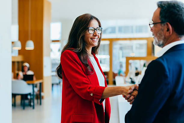 istock Business professionals shaking hands in an office setting 2222451411