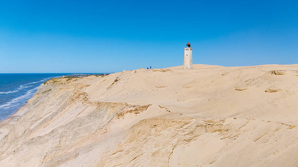 istock Stunning coastal view with lighthouse overlooking sandy dunes in Denmark 2222451649