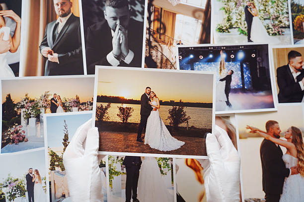 istock hands in white gloves and Beautiful printed wedding photos. 2222452543