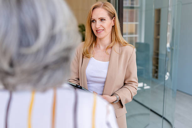 istock Two colleagues engaged in a professional discussion in a modern office environment during work hours 2222452599