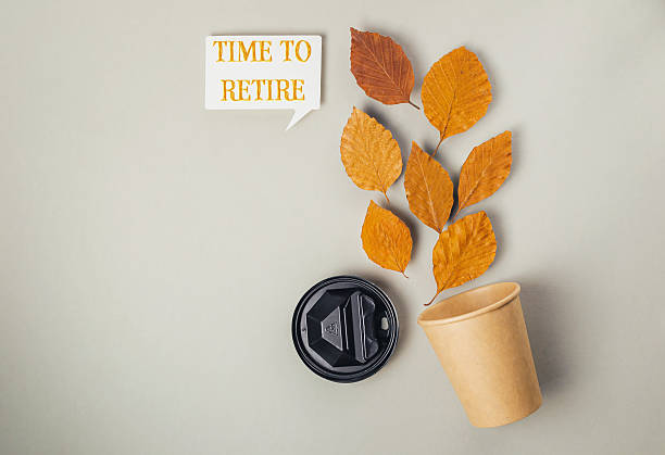 istock Coffee cup with a leaf on it and the words Time to Retire written on it 2222453009