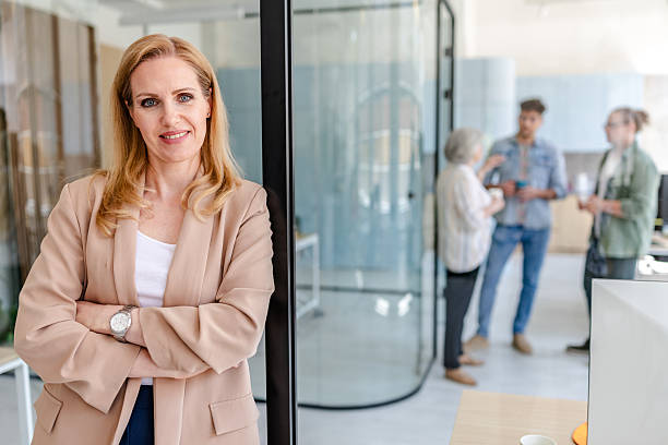 istock Professionals engage in discussion while a confident woman observes in a modern office setting during working hours 2222453243