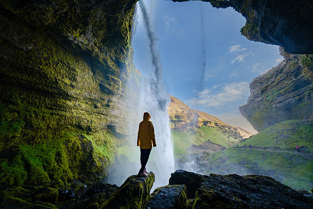 istock View from inside Kvernufoss waterfall showcasing a person exploring Icelandic nature 2222453427