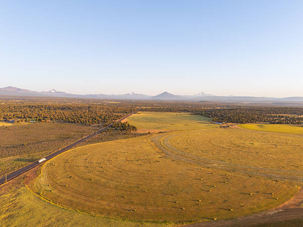 istock Mount Jefferson, Three Fingered Jack, Mount Washington and Black butte, from highway 20 in Oregon, USA, near Bend, car driving away, aerial morning view 2222453880