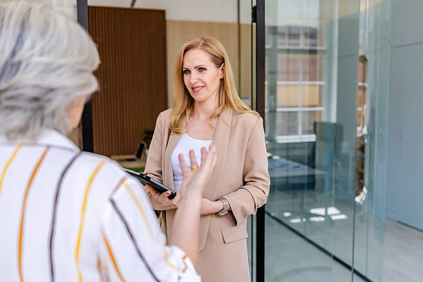 istock Business professionals engage in a discussion inside a modern office environment during work hours 2222454817