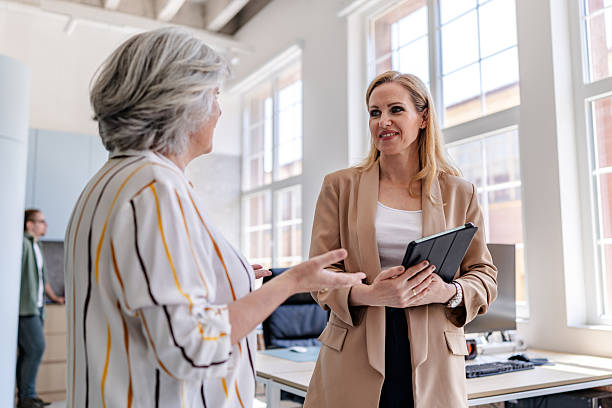 istock Business colleagues engage in conversation during a productive day in a modern office environment 2222454883