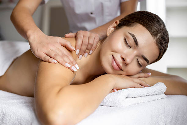 istock Young woman enjoying a massage at a spa 2222455736