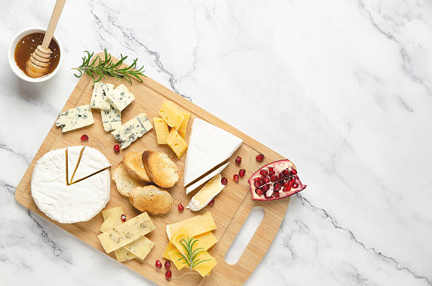 istock Assorted cheese with pomegranate and honey on a wooden board. 2222458910
