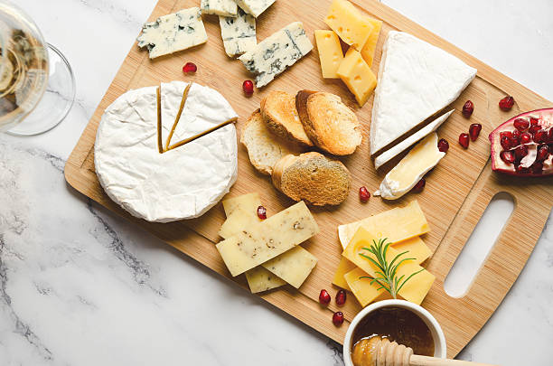 istock Assorted cheese with pomegranate and honey on a wooden board. 2222458915