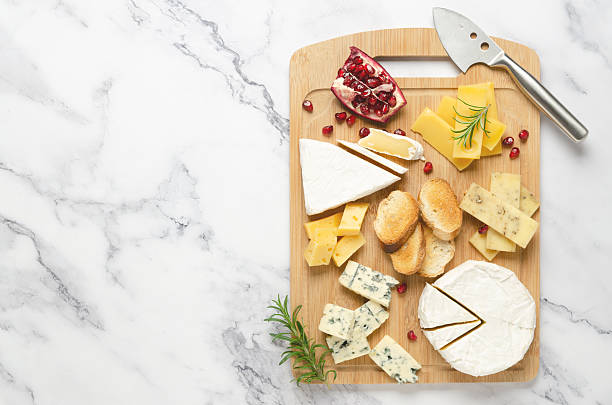 istock Assorted cheese with pomegranate and honey on a wooden board. 2222458926