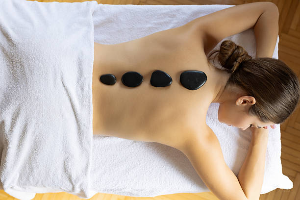 Unrecognizable woman at a spa having lastone therapy