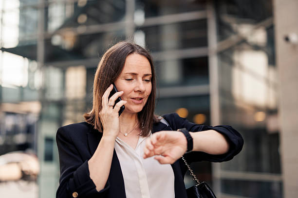 istock Businesswoman using phone, checking time and going to job 2222460746