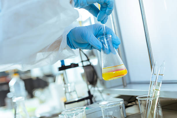 istock Laboratory Testing and Quality Control of Oil Sample by Scientist with Pipette and Glassware in Modern Lab 2222462766