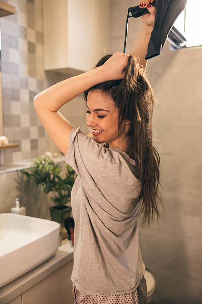 istock Woman Doing Blowout At Home 2222462782
