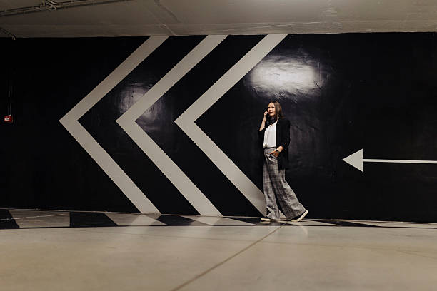 istock Woman using smart phone in public garage 2222462965