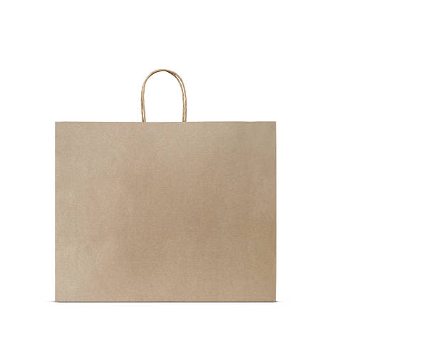 istock Large empty brown kraft paper bag isolated on white background. Eco-friendly shopping bag made of recycled paper. Template with copy space. 2222463553