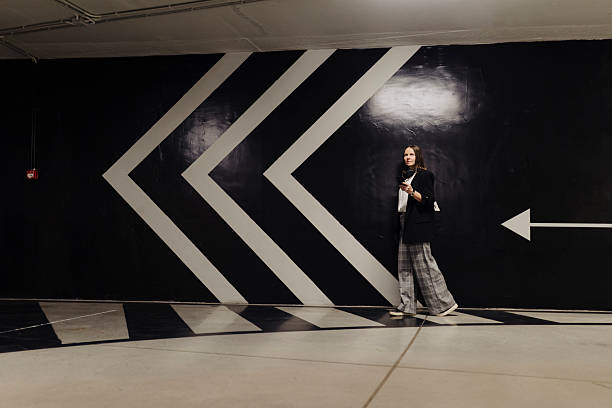 istock Woman using smart phone in public garage 2222463724