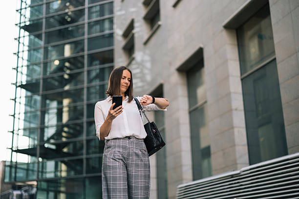 istock Businesswoman using phone, checking time and going to job 2222466277