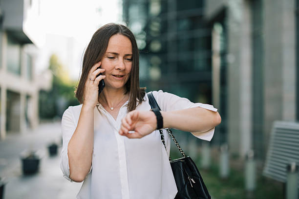 istock Businesswoman using phone, checking time and going to job 2222466400