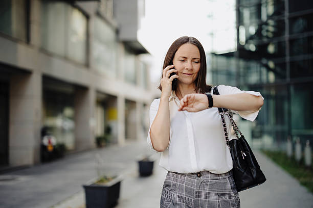 istock Businesswoman using phone, checking time and going to job 2222466574
