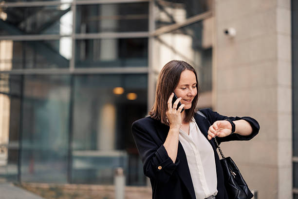 istock Businesswoman using phone, checking time and going to job 2222466634