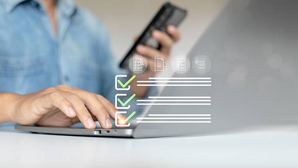 istock A person is using a laptop and holding a smartphone while interacting with a virtual checklist 2222468221