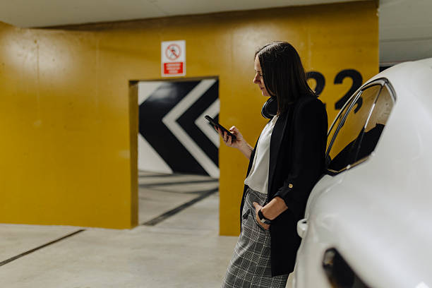 istock Woman using phone in public garage 2222468289
