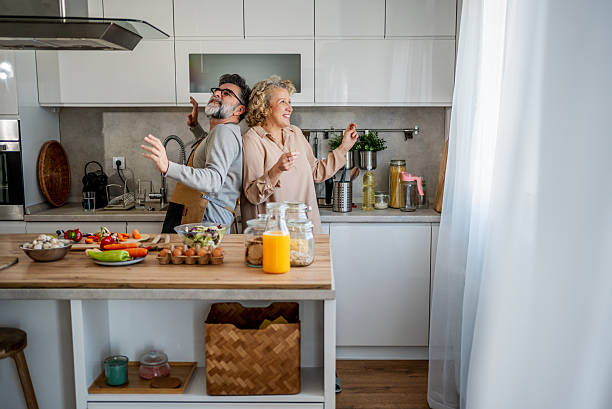 istock Smiling mature couple dancing together in their kitchen 2222469753
