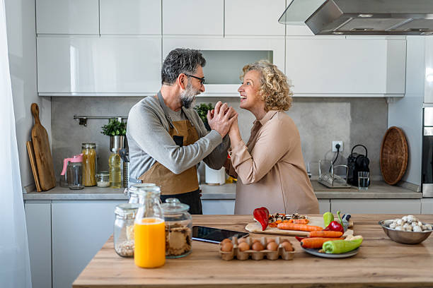 istock Mature couple making a fresh healthy meal 2222469806