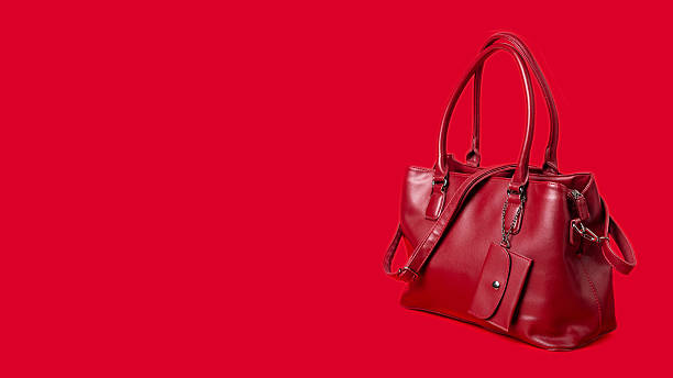 istock Red women's leather bag on a red background. Banner, space for text. 2222469893
