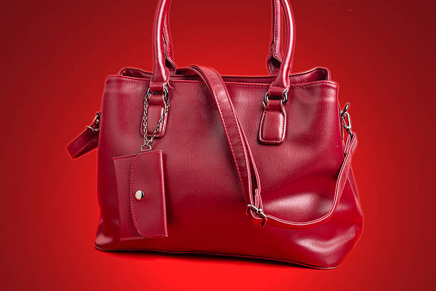 istock Red women's leather bag on a red background. 2222469894